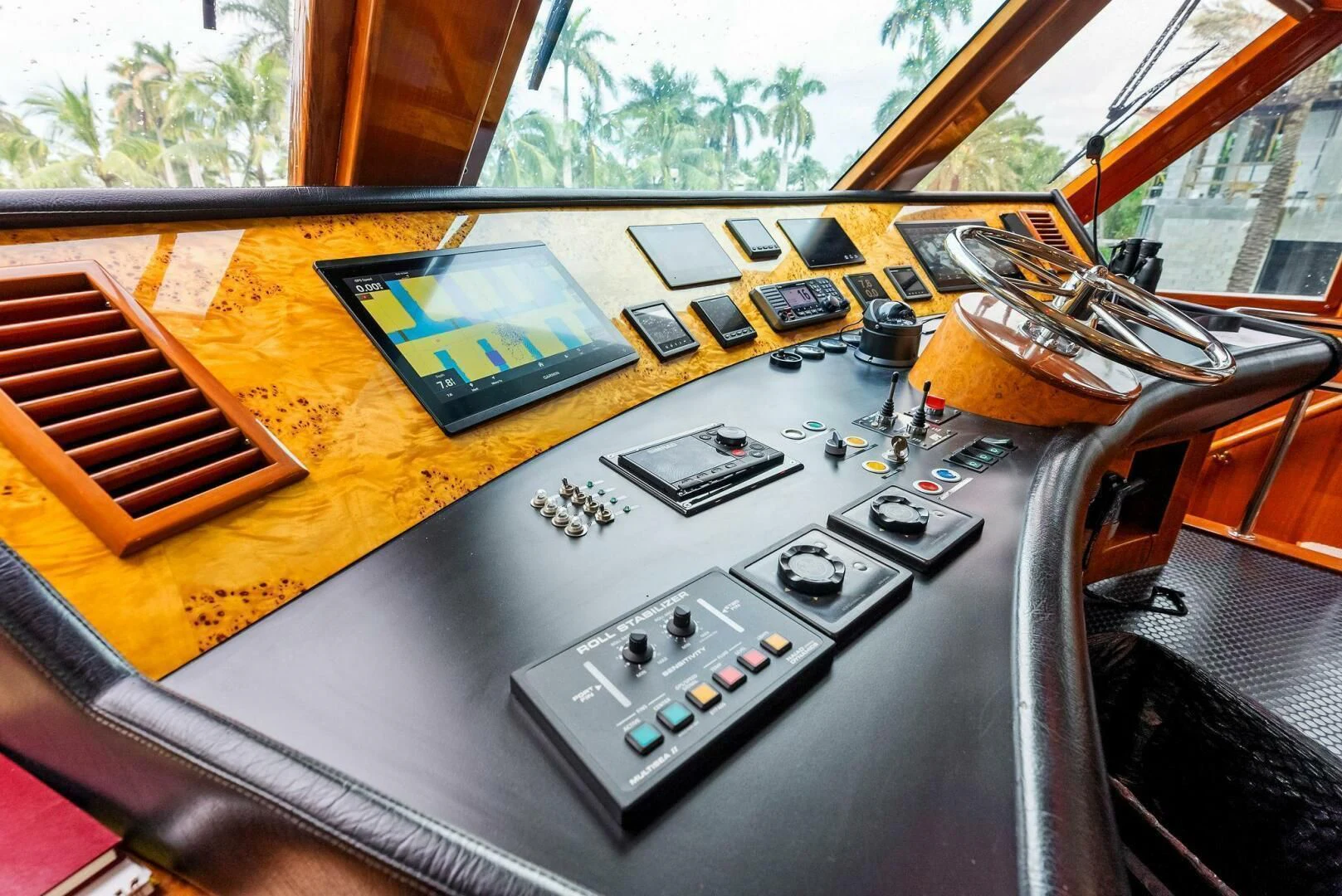 a table with a game console and a game controller on it aboard TORTUGA Yacht for Sale