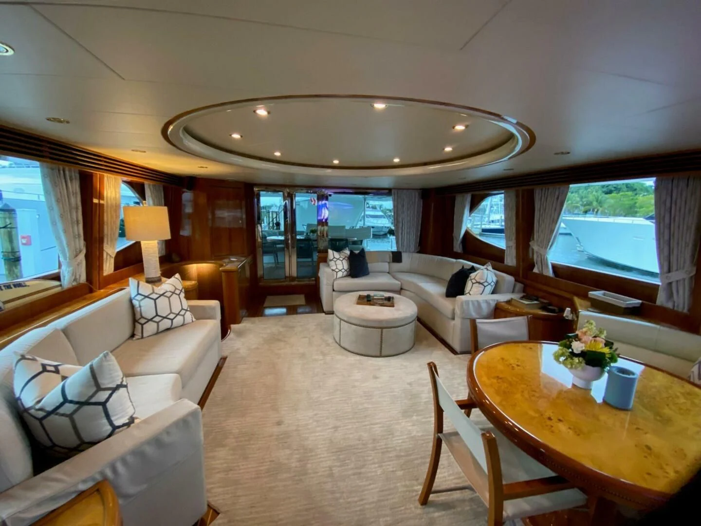 a living room with a large chandelier aboard TORTUGA Yacht for Sale