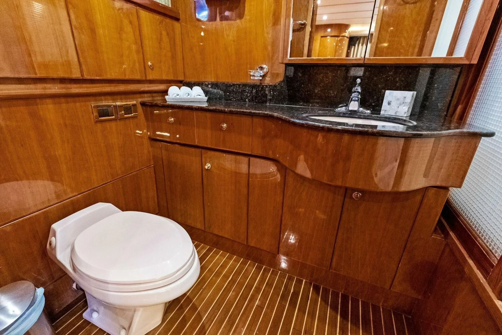 a bathroom with wooden cabinets aboard TORTUGA Yacht for Sale