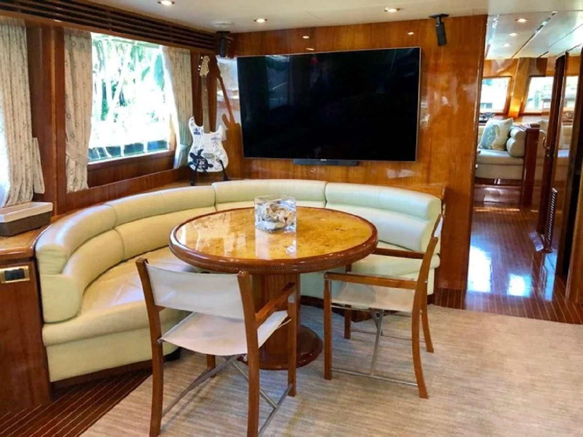 a table and chairs in a room aboard TORTUGA Yacht for Sale