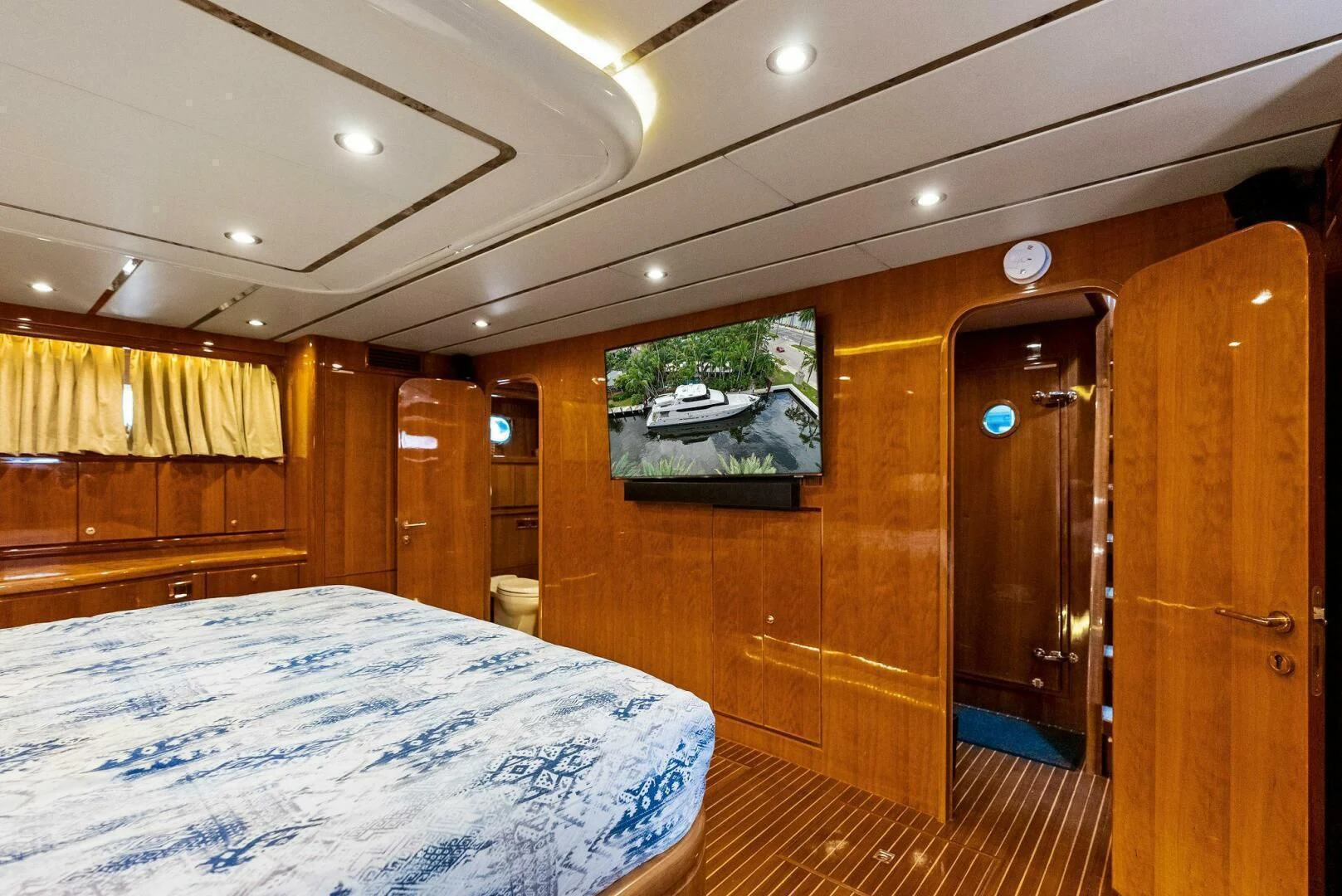 a room with a bed and a wood door aboard TORTUGA Yacht for Sale