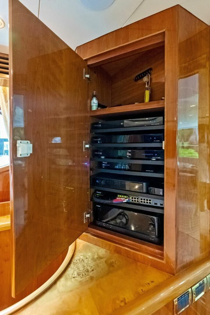 a wooden cabinet with a black shelf aboard TORTUGA Yacht for Sale