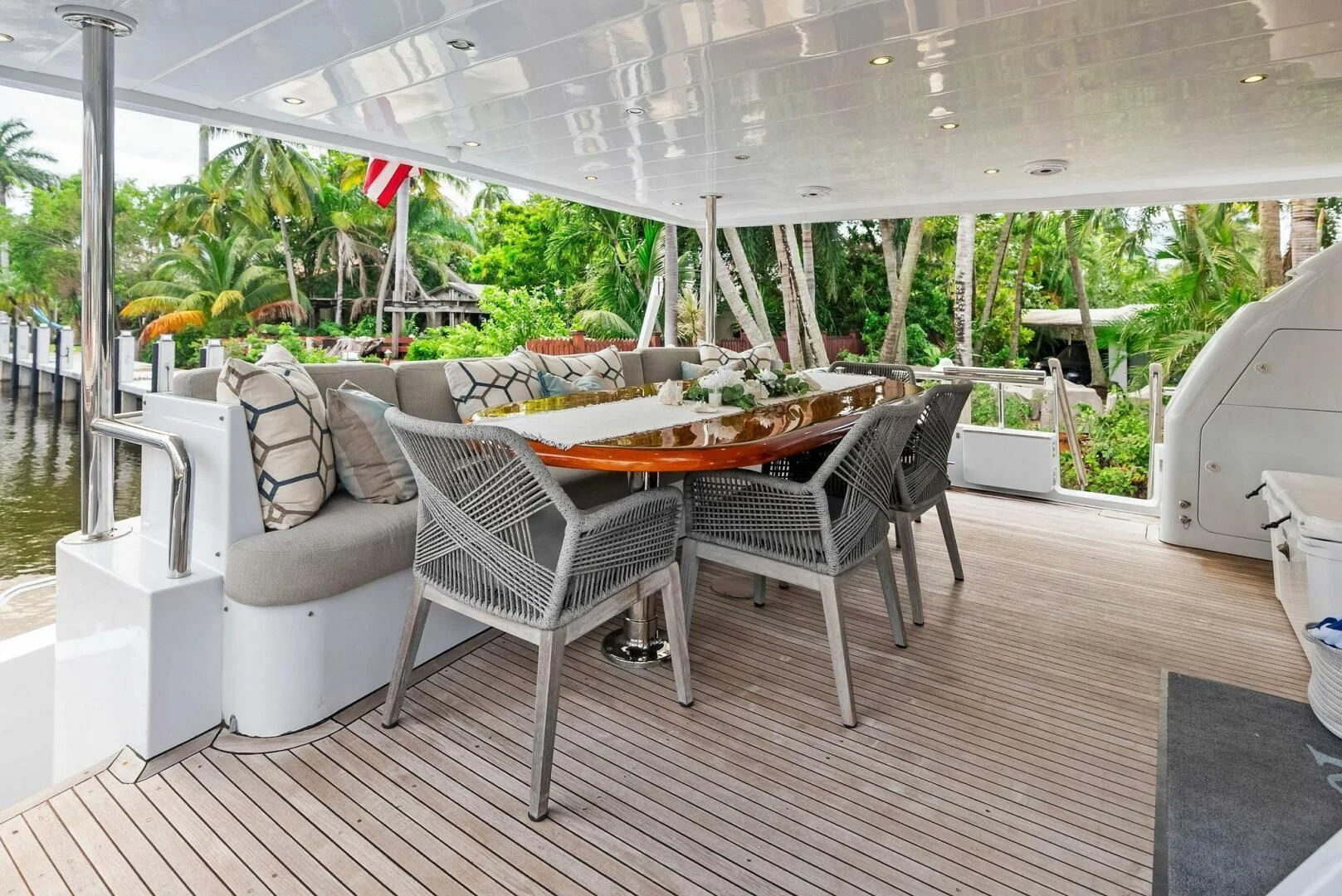 a patio with a table and chairs aboard TORTUGA Yacht for Sale
