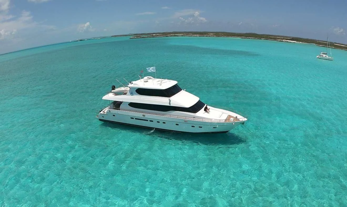 a white boat in the water aboard TORTUGA Yacht for Sale