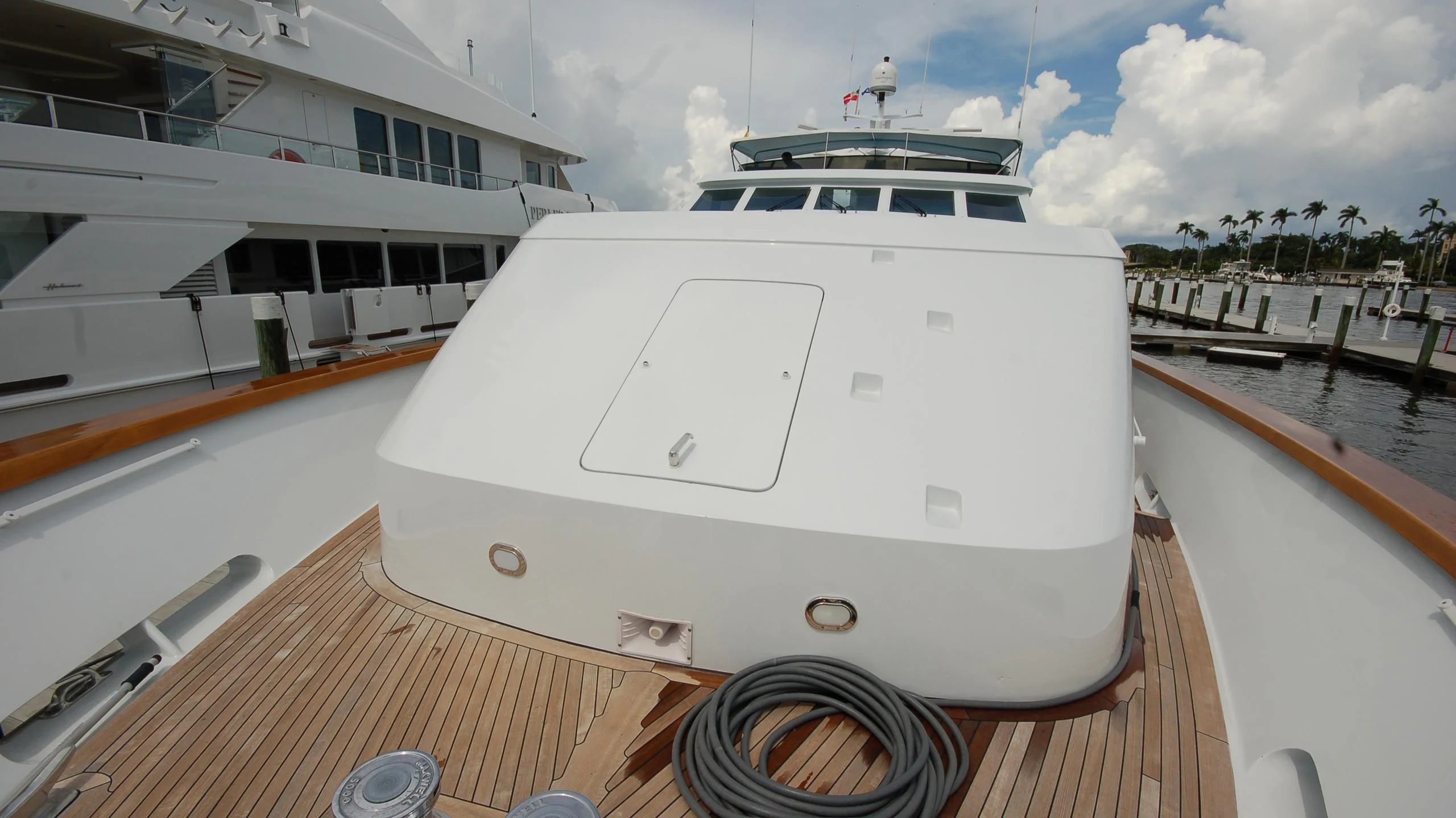 a white yacht on a dock aboard CONTRARIAN ROSE Yacht for Sale