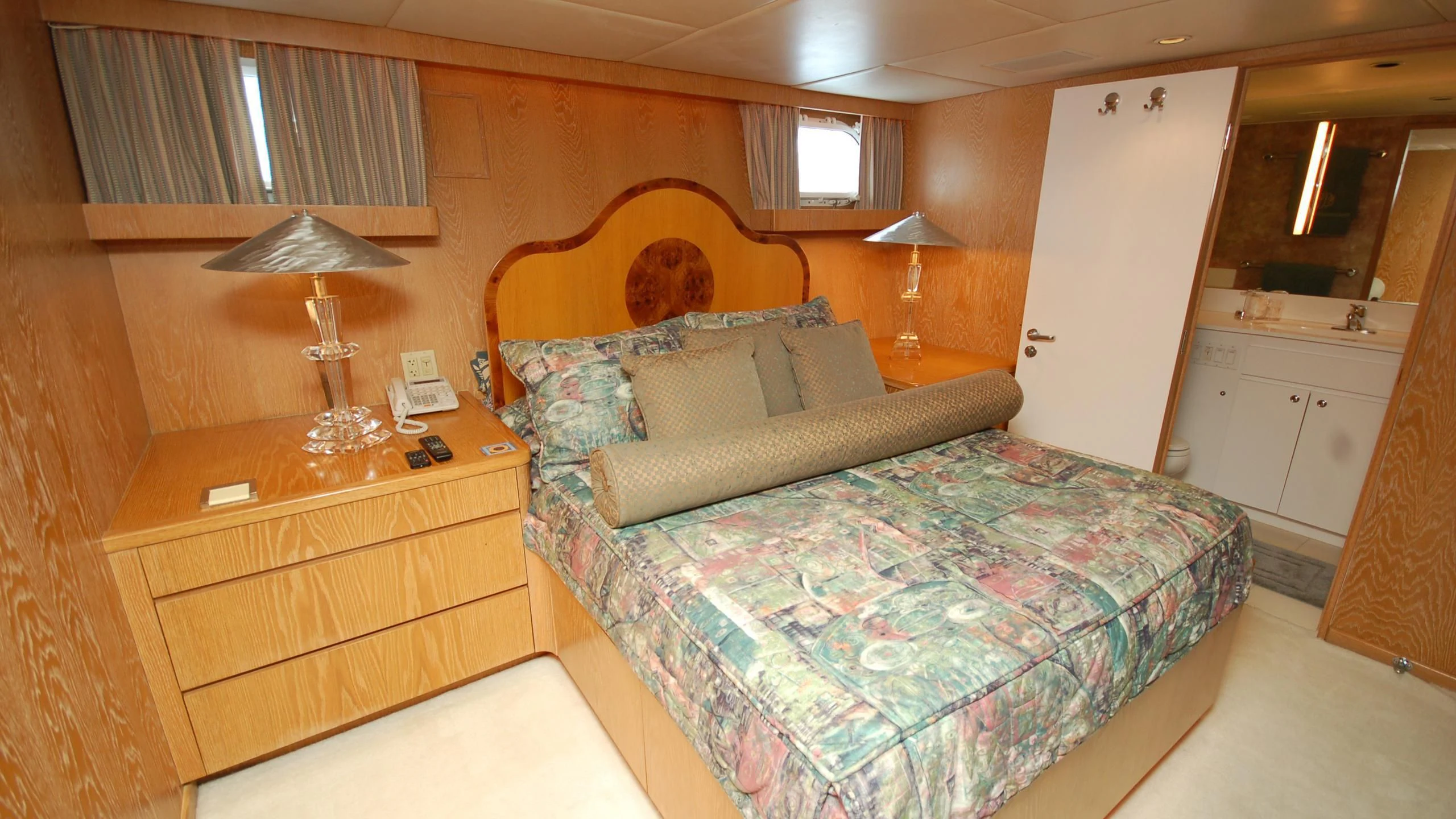 a bedroom with a bed and a desk aboard CONTRARIAN ROSE Yacht for Sale