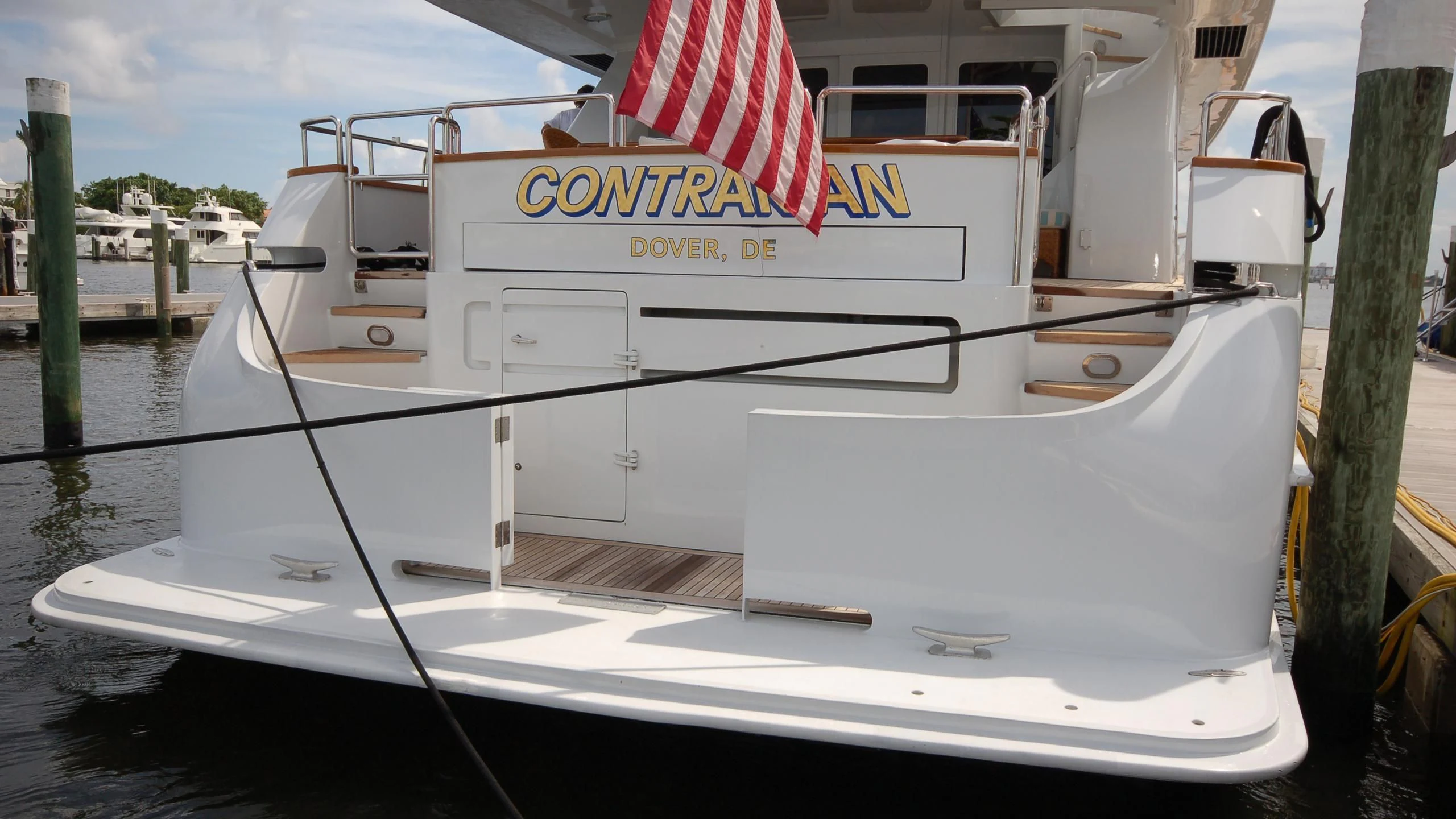a boat with a flag on the front aboard CONTRARIAN ROSE Yacht for Sale