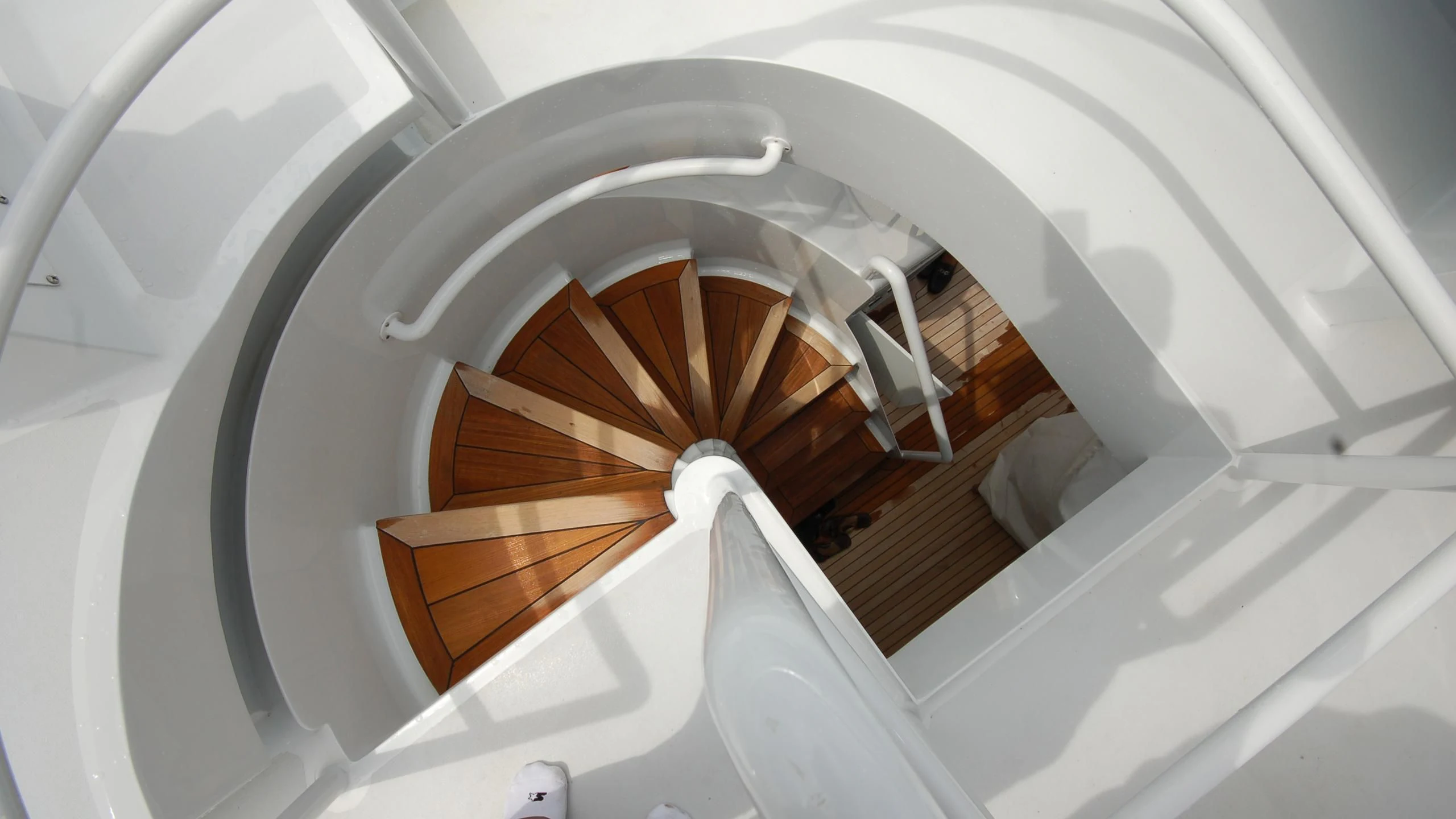 a white spiral staircase aboard CONTRARIAN ROSE Yacht for Sale