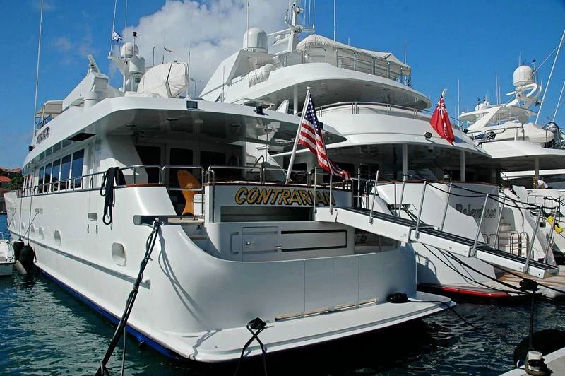 a large white boat with flags on it aboard CONTRARIAN ROSE Yacht for Sale