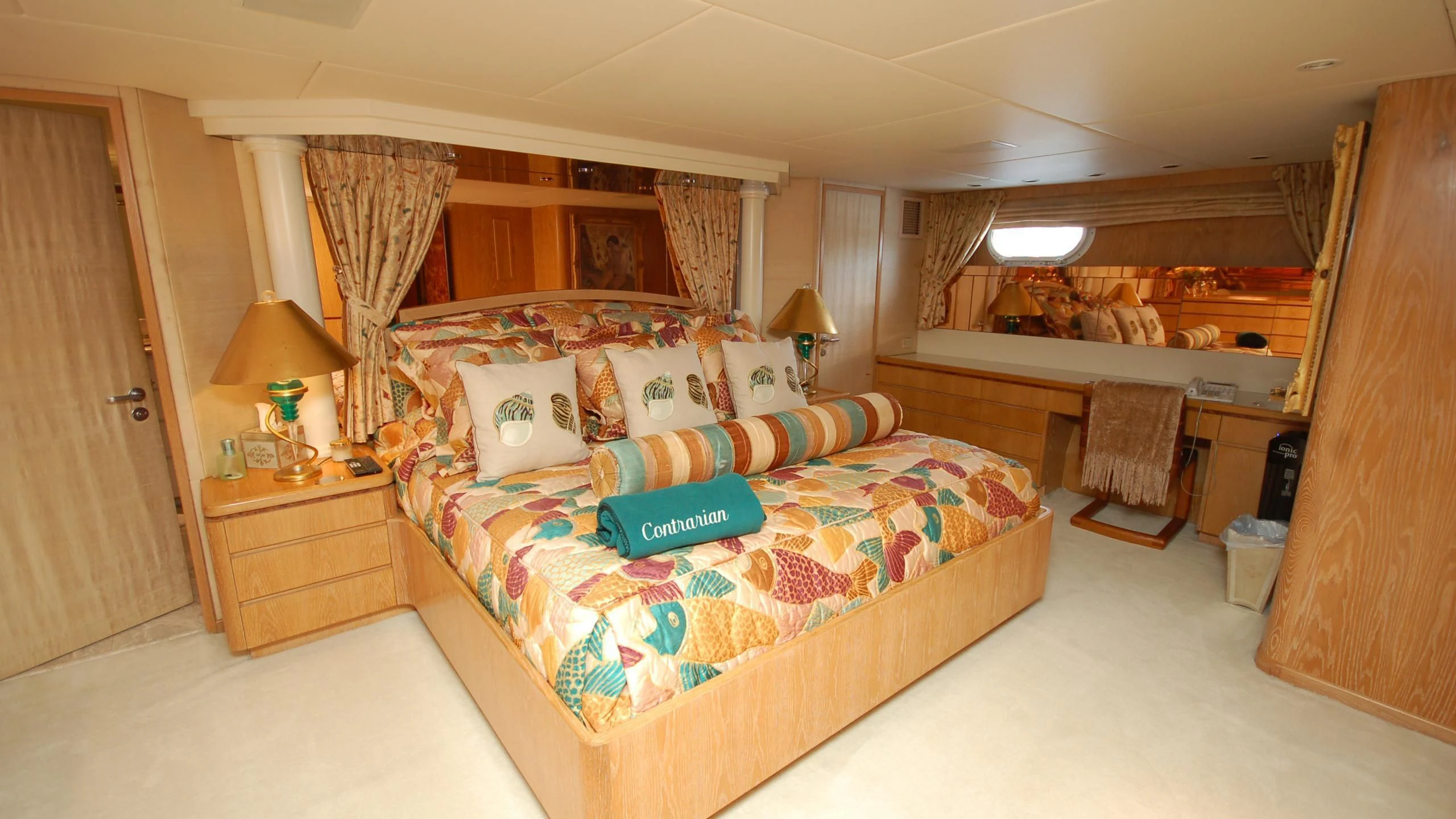 a bedroom with a bed and a desk aboard CONTRARIAN ROSE Yacht for Sale