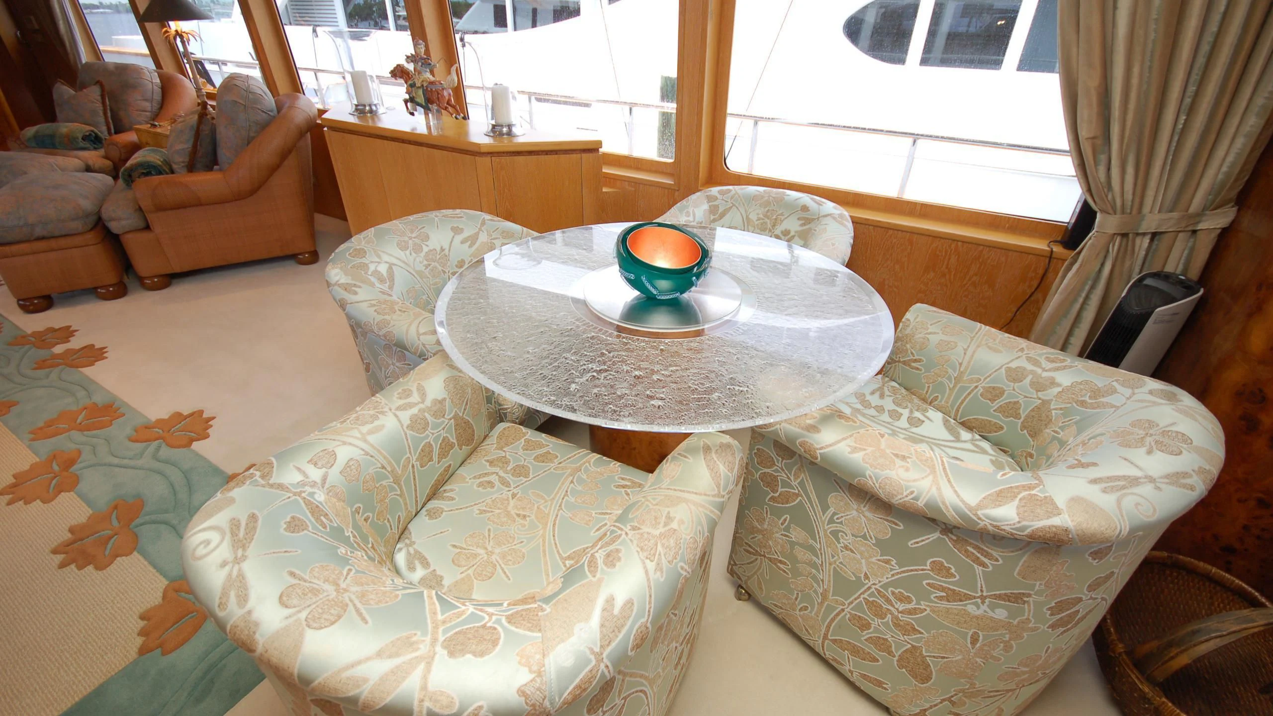 a living room with a round table and a couch aboard CONTRARIAN ROSE Yacht for Sale