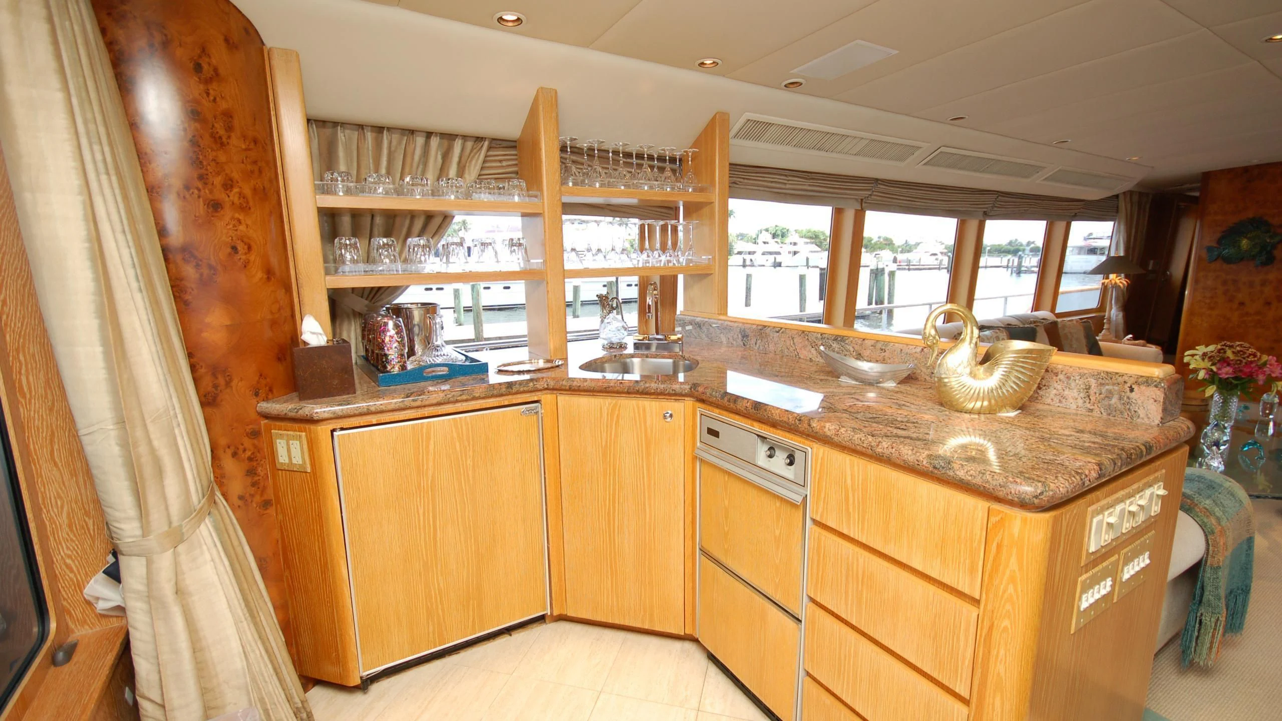 a kitchen with wooden cabinets aboard CONTRARIAN ROSE Yacht for Sale