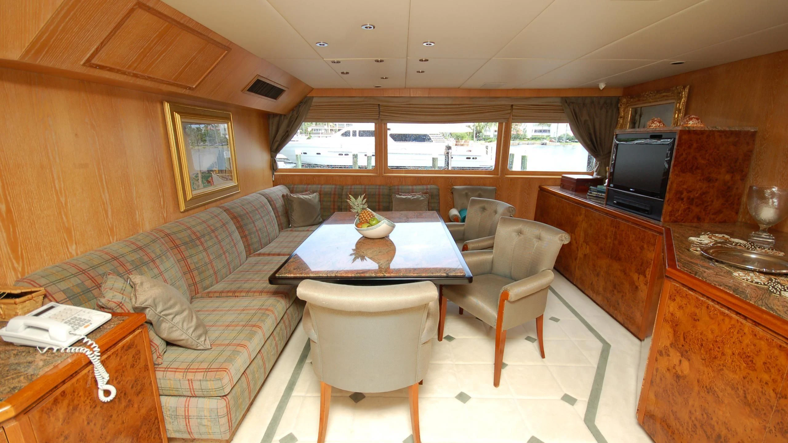 a living room with a couch and a table aboard CONTRARIAN ROSE Yacht for Sale