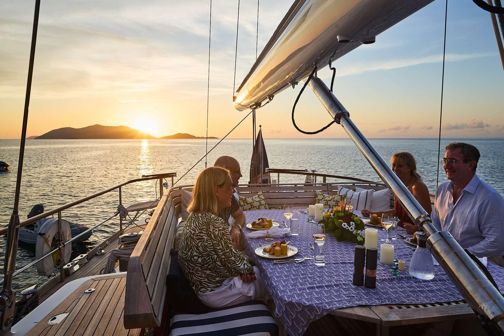 a group of people sitting on a boat with a view of the ocean aboard ABIDE Yacht for Sale
