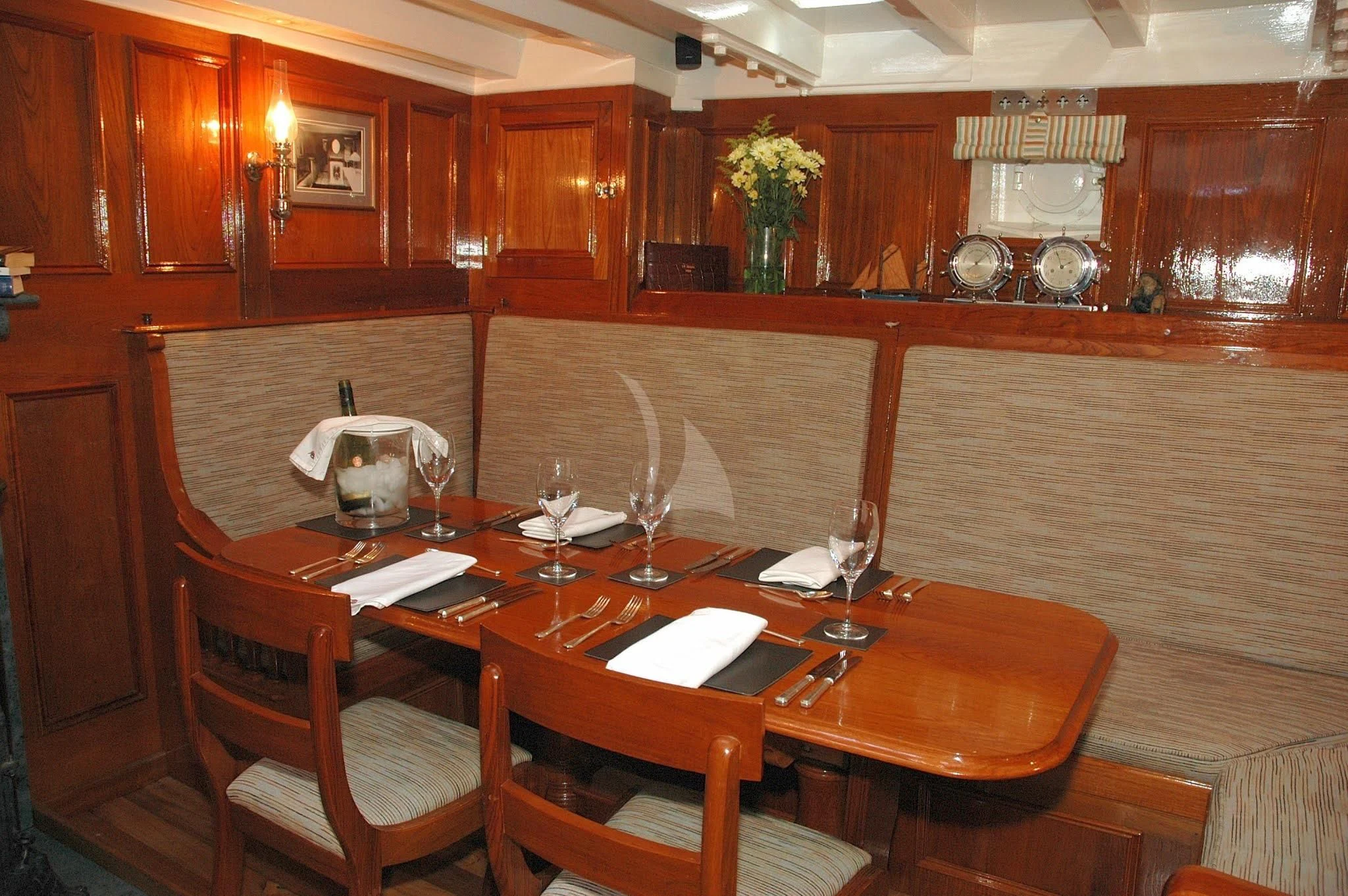 a dining table with wine glasses aboard HALCYON Yacht for Sale