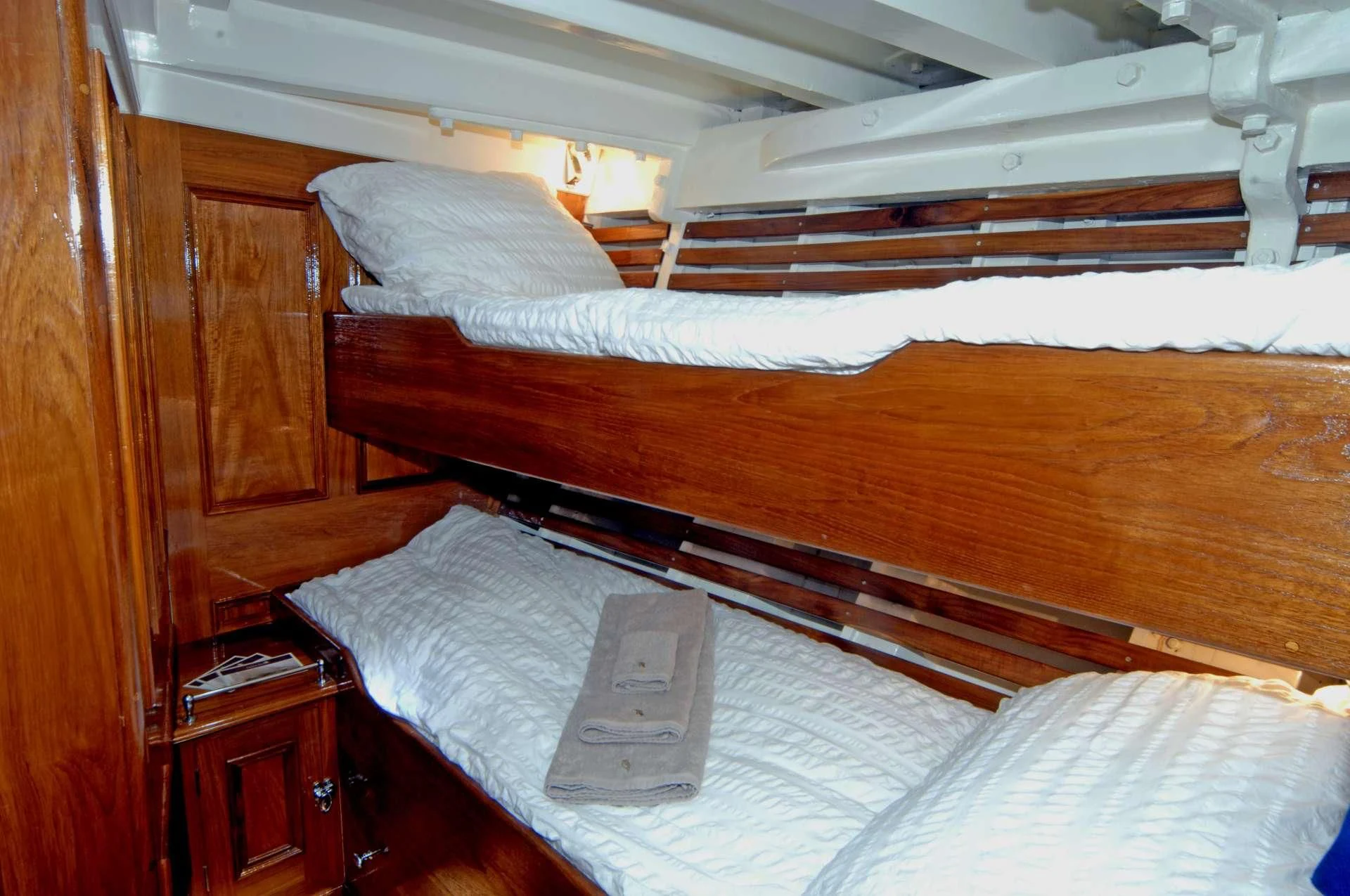 a bed with a book on it aboard HALCYON Yacht for Sale
