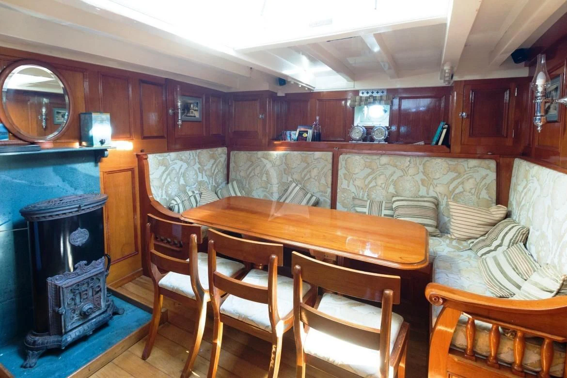 a room with a table and chairs aboard HALCYON Yacht for Sale