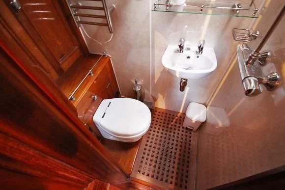 a bathroom with a toilet sink and a mirror aboard HALCYON Yacht for Sale