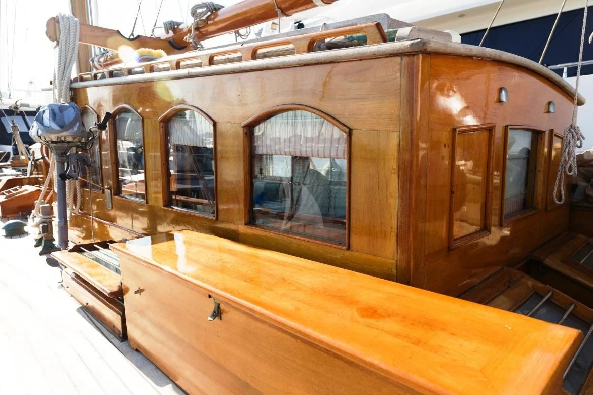 a wooden boat with a large window aboard HALCYON Yacht for Sale