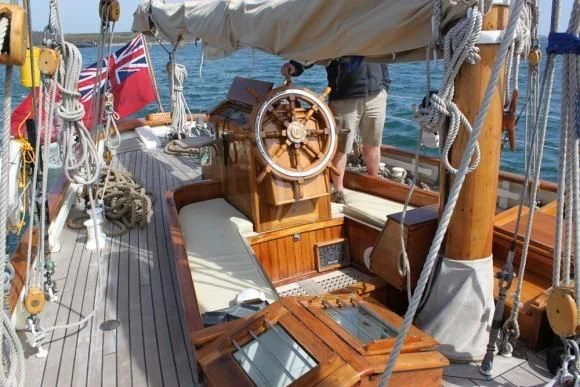 a wooden boat with ropes aboard HALCYON Yacht for Sale