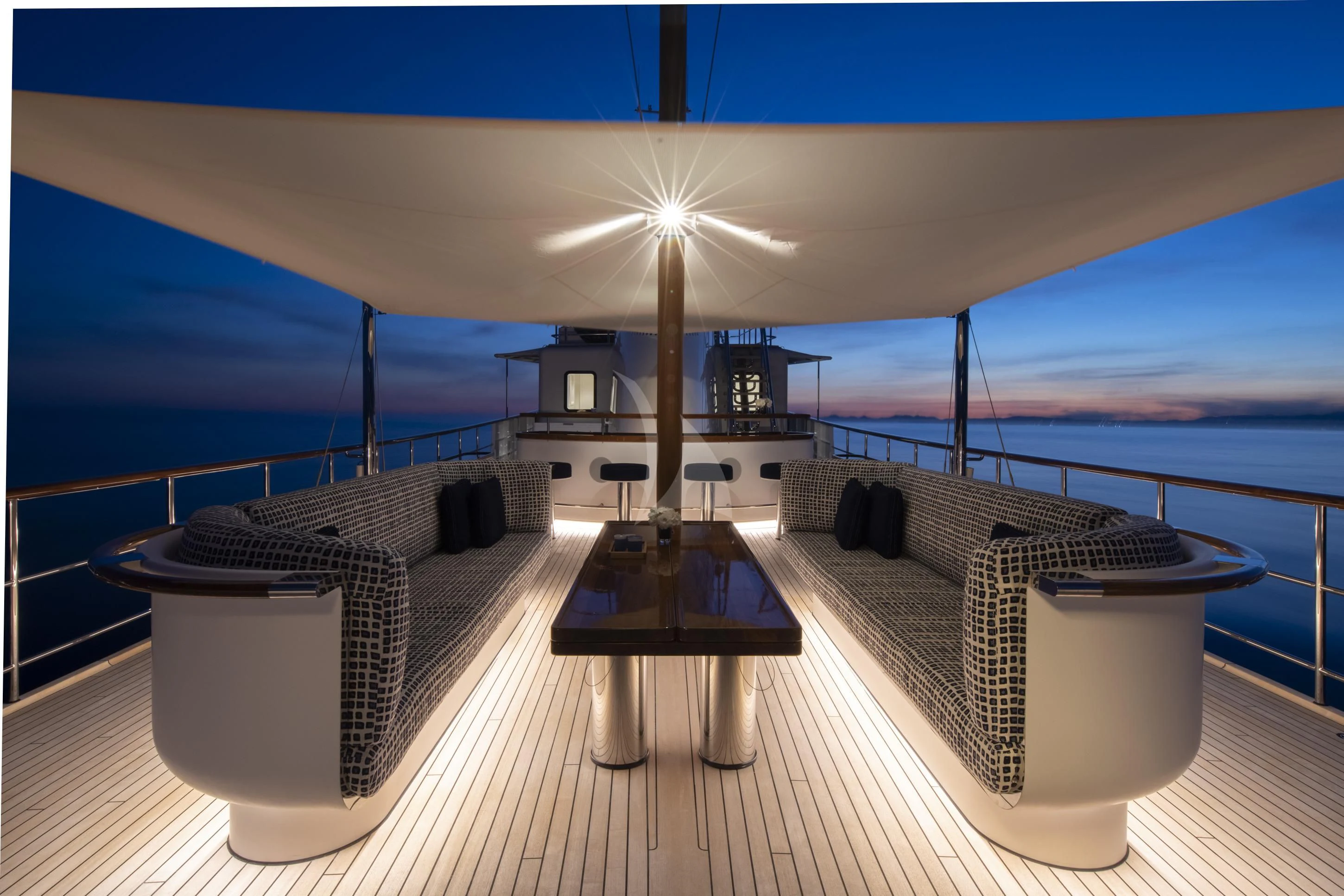 a deck with a view of the ocean and the sun aboard ISTROS Yacht for Sale