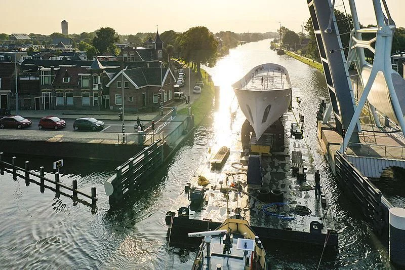 a canal with boats and cars aboard ISTROS Yacht for Sale