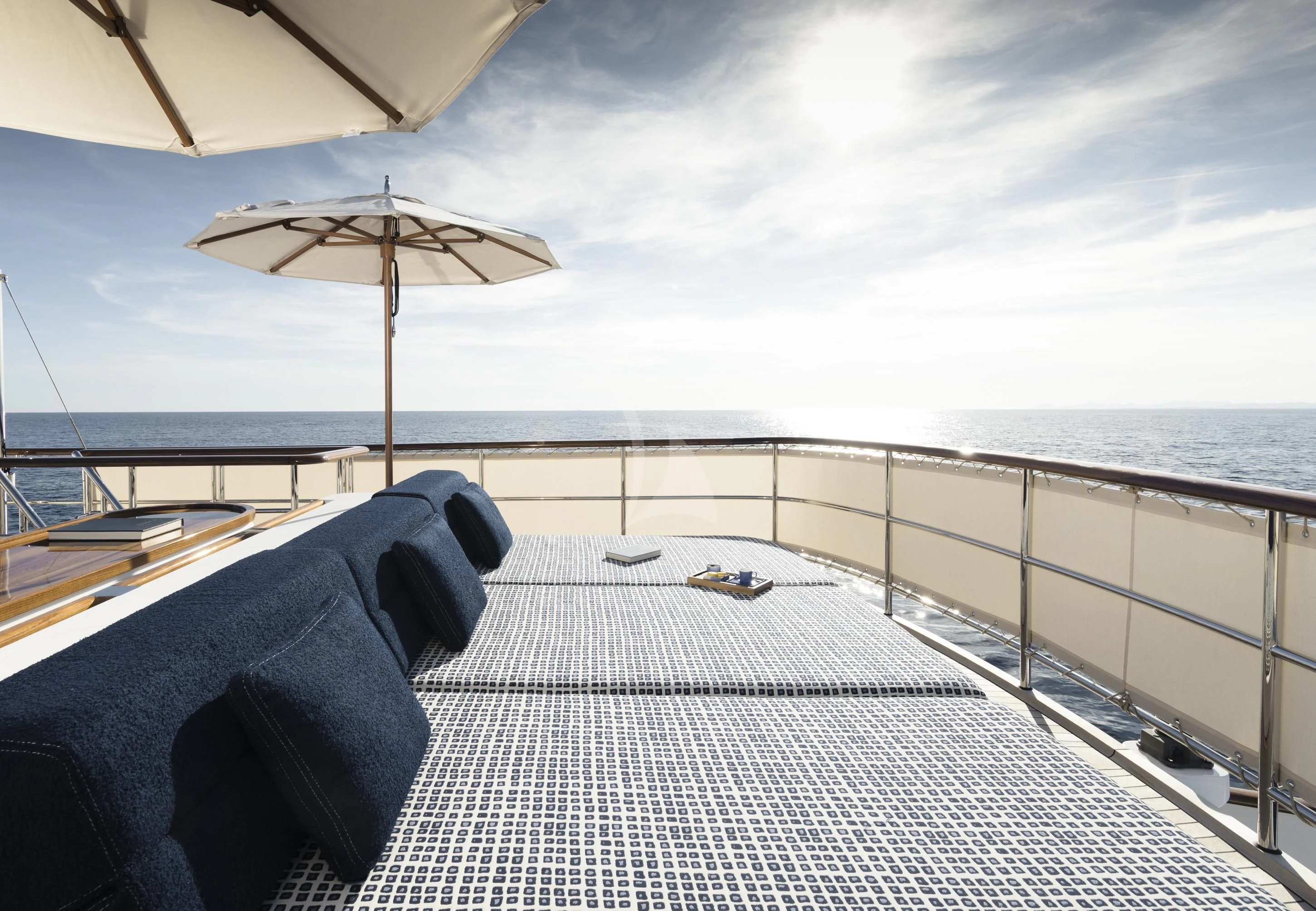 a person sitting on a deck with an umbrella over their head aboard ISTROS Yacht for Sale