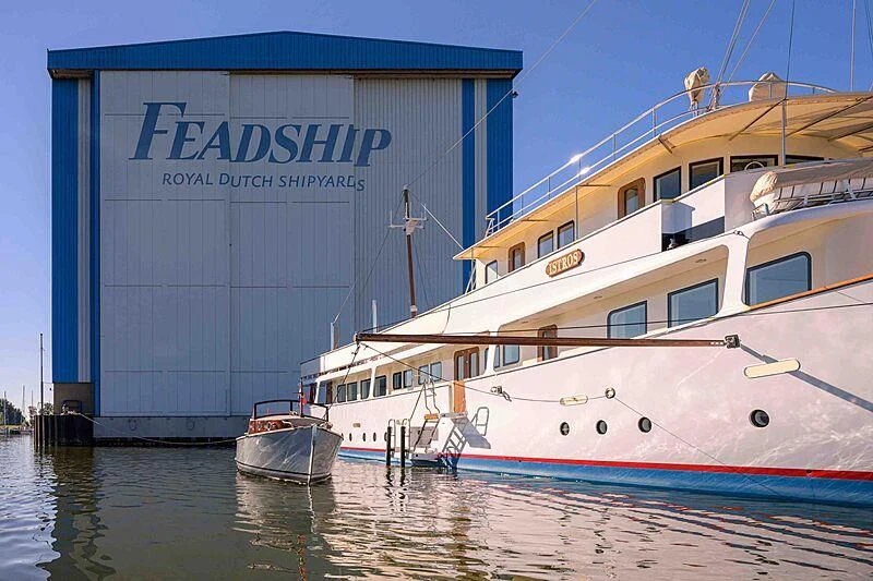 a couple of boats sit in a harbor aboard ISTROS Yacht for Sale