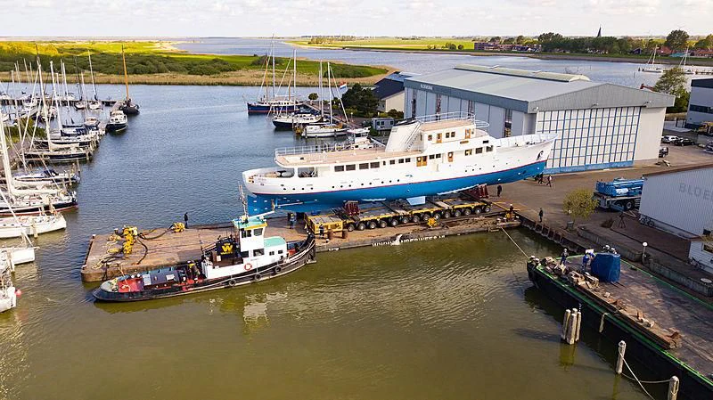 a large ship docked at a pier aboard ISTROS Yacht for Sale