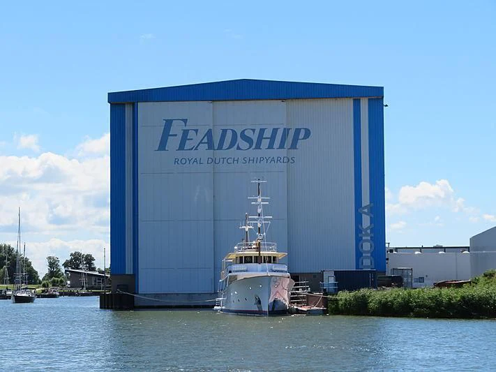 a large white container ship aboard ISTROS Yacht for Sale