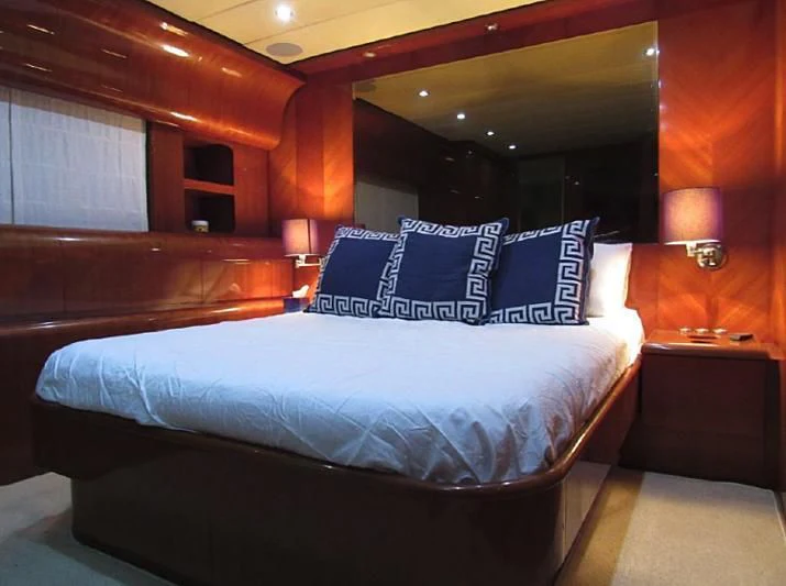 a bed with a blue and white bed spread aboard ENDERA Yacht for Sale