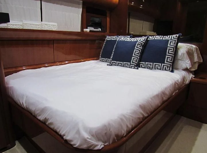 a bed with white sheets aboard ENDERA Yacht for Sale