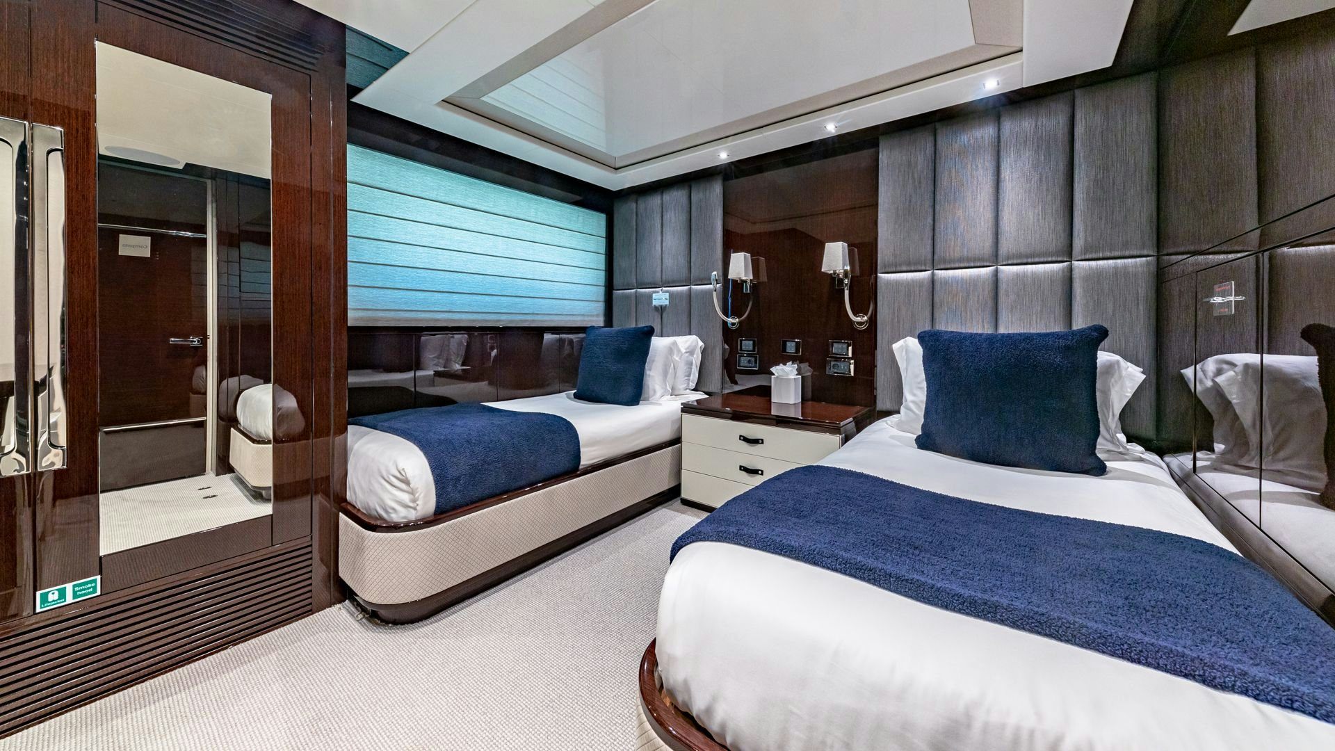 a room with a bed and a mirror aboard CAPTAIN MORGAN III Yacht for Sale