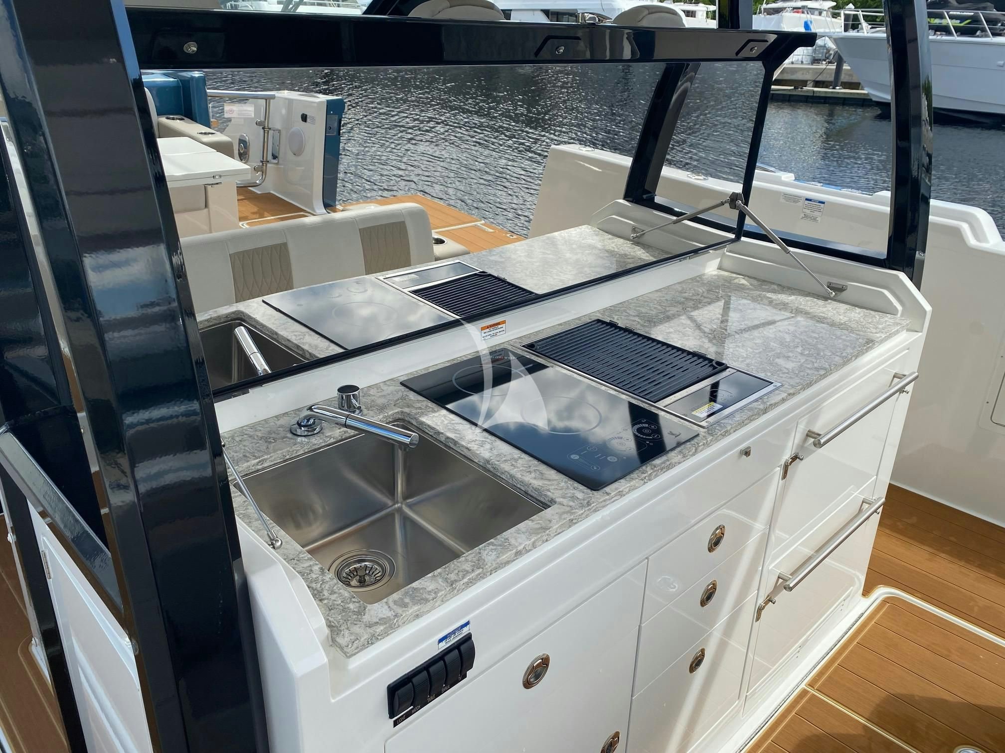 a large white kitchen with a glass top and a sink aboard CAPTAIN MORGAN III Yacht for Sale