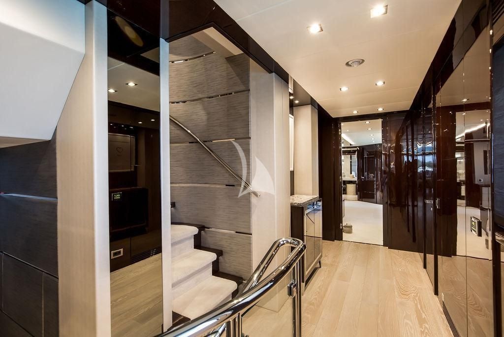 a hallway with white walls and stairs aboard CAPTAIN MORGAN III Yacht for Sale