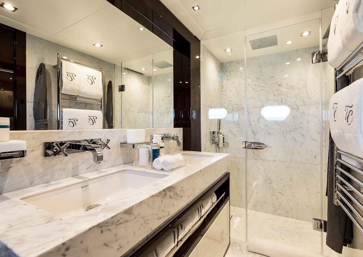 a bathroom with a large mirror aboard CAPTAIN MORGAN III Yacht for Sale