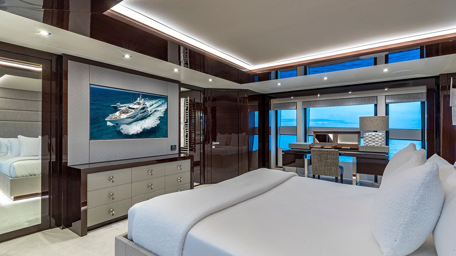 a room with a bed and a tv on the wall aboard CAPTAIN MORGAN III Yacht for Sale