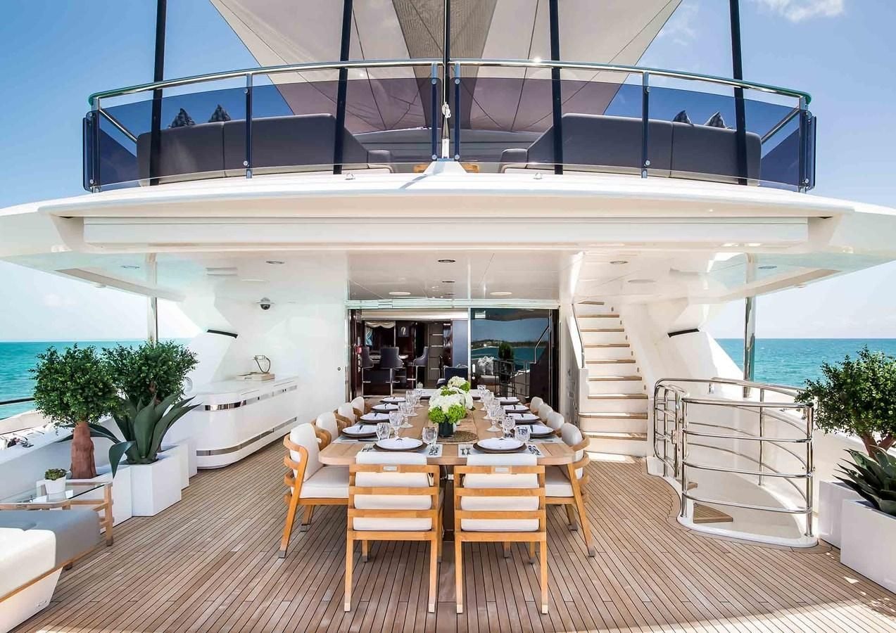a room with tables and chairs aboard CAPTAIN MORGAN III Yacht for Sale