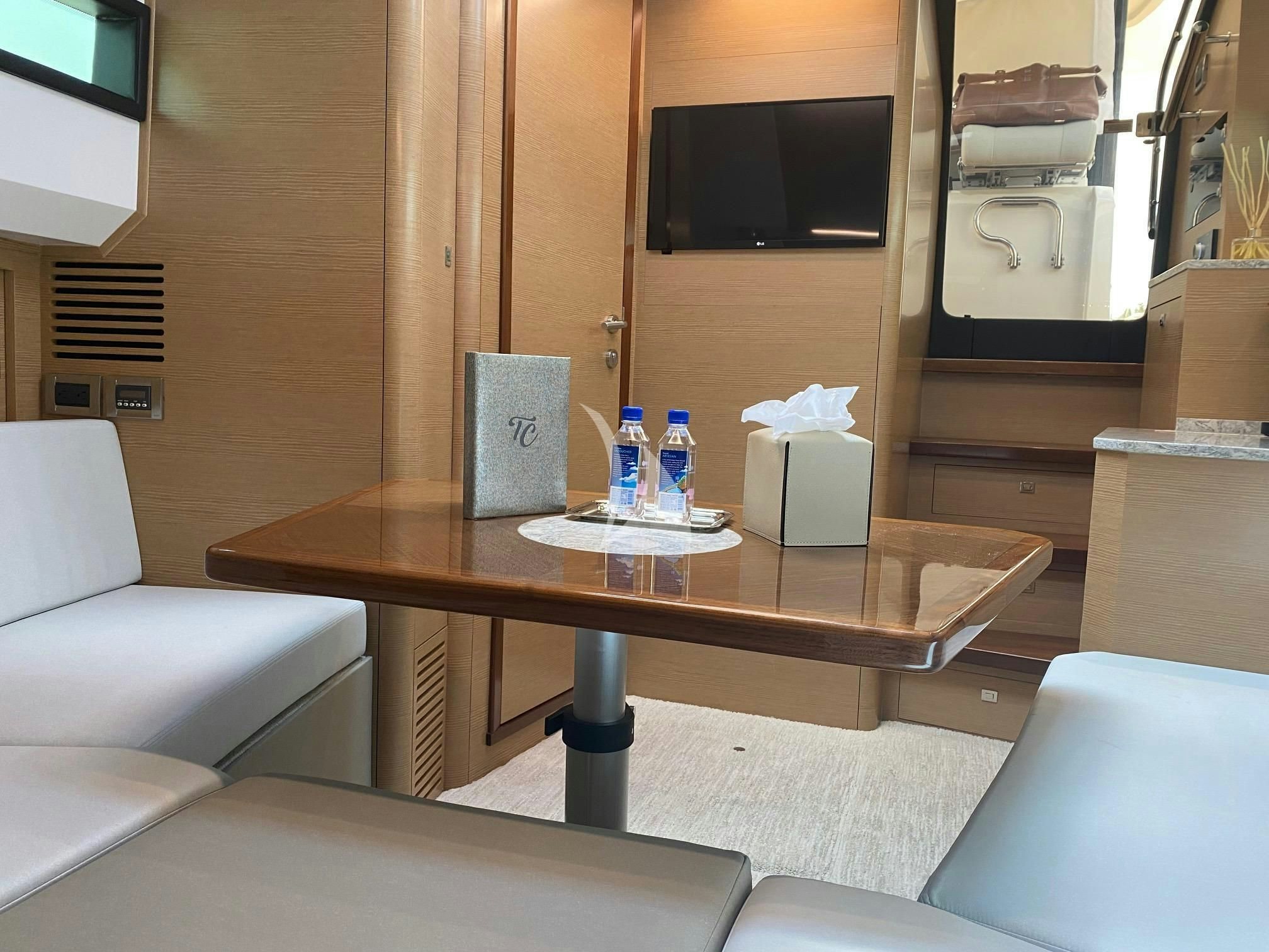 a table with a couch and a television on it aboard CAPTAIN MORGAN III Yacht for Sale