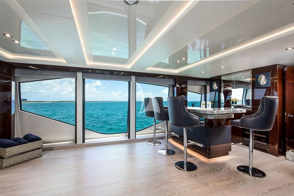 a room with a table chairs and a couch aboard CAPTAIN MORGAN III Yacht for Sale