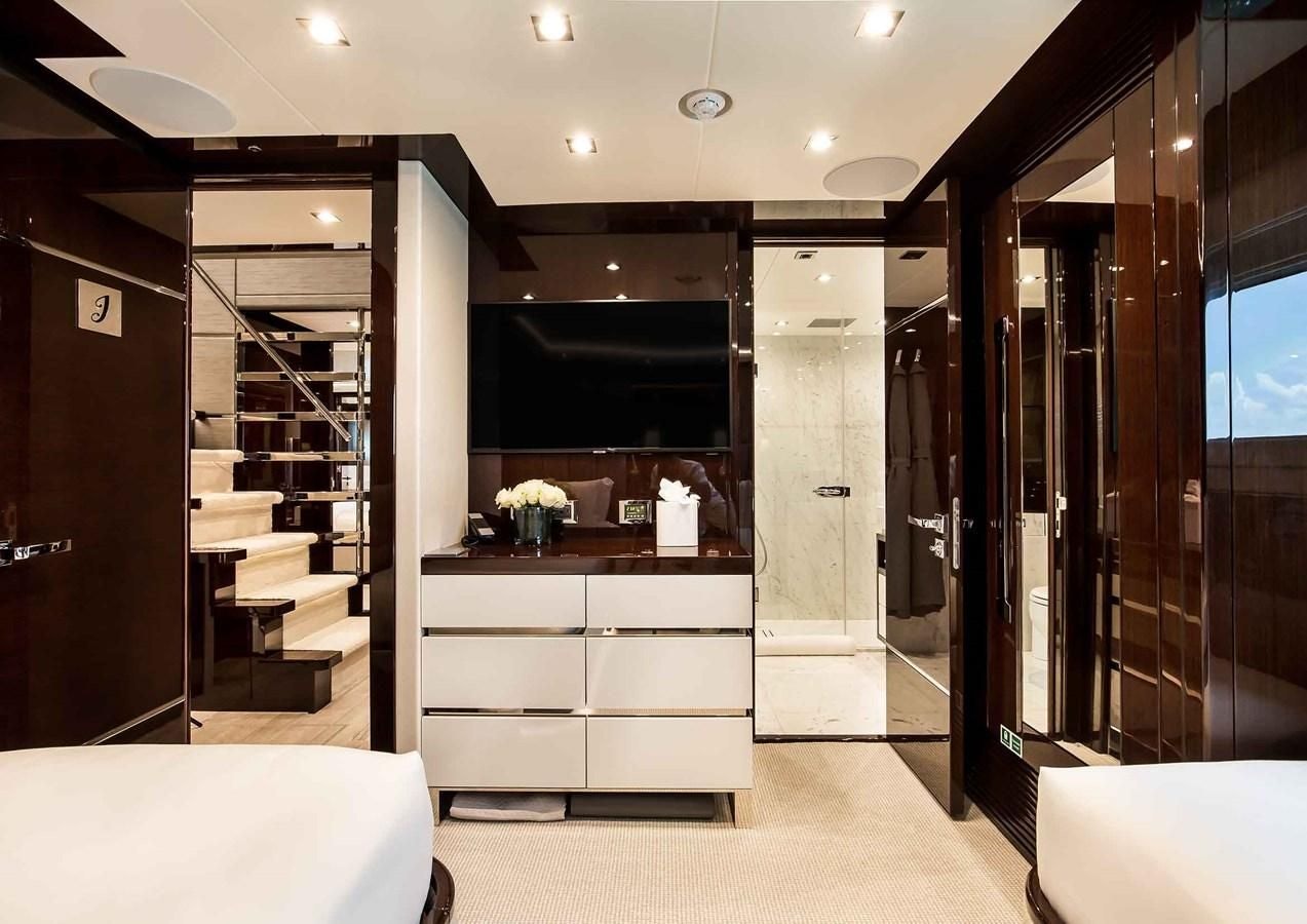 a room with a bed and a desk aboard CAPTAIN MORGAN III Yacht for Sale