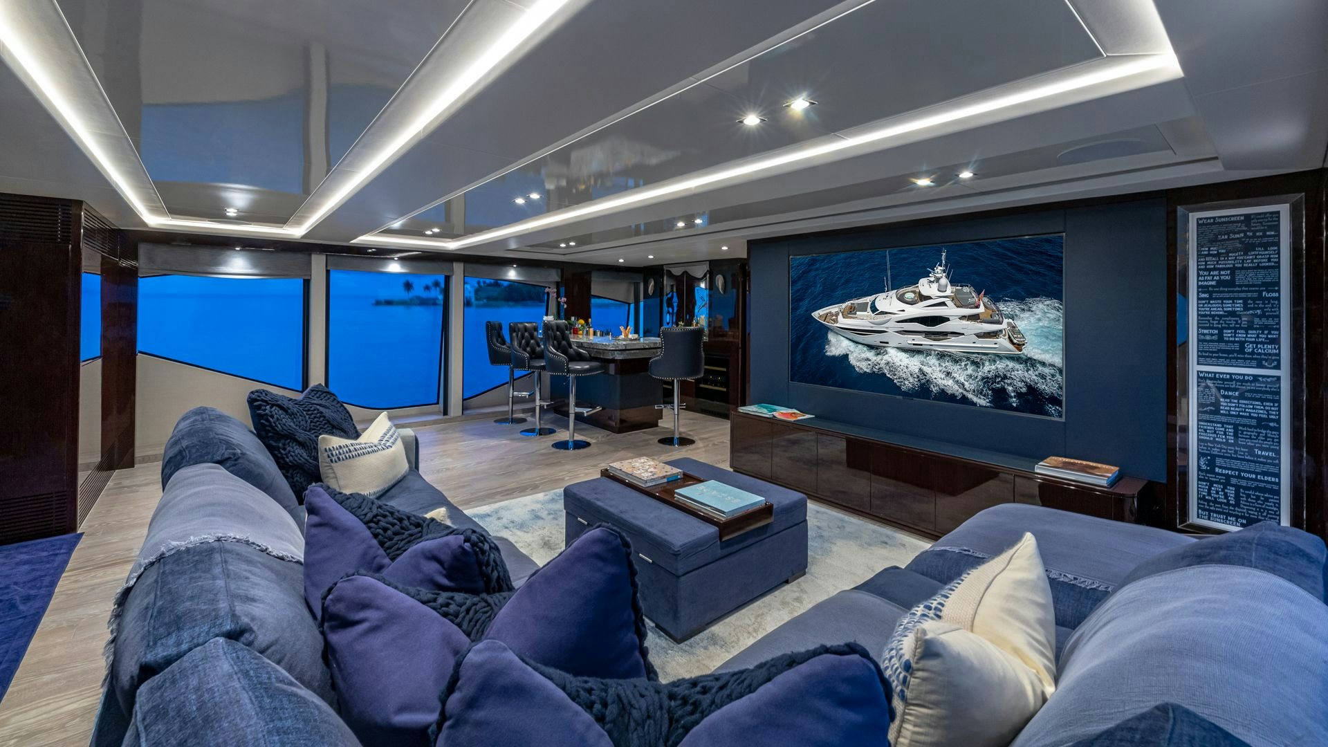 a large living room with a large screen aboard CAPTAIN MORGAN III Yacht for Sale