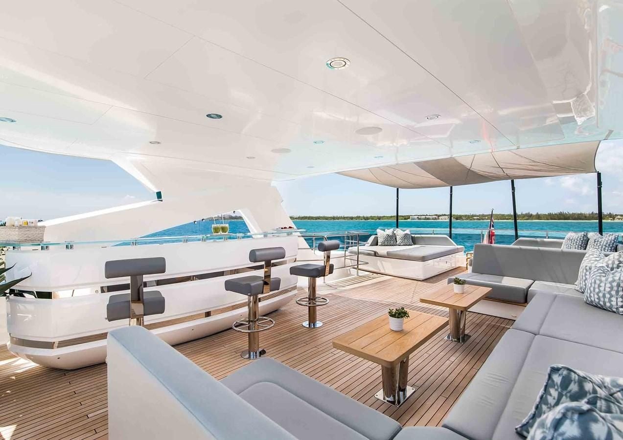 a room with a pool and a deck with a large swimming pool aboard CAPTAIN MORGAN III Yacht for Sale