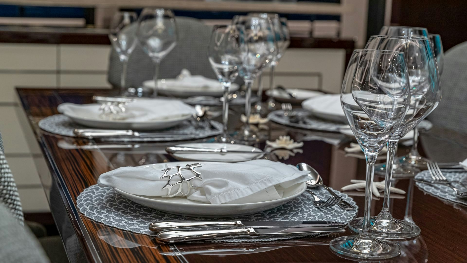 a table with plates and glasses aboard CAPTAIN MORGAN III Yacht for Sale