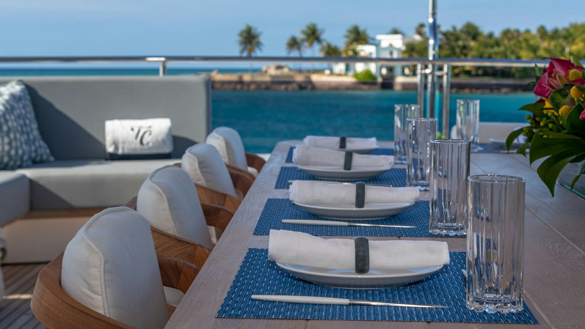 a table with plates and glasses on it aboard CAPTAIN MORGAN III Yacht for Sale