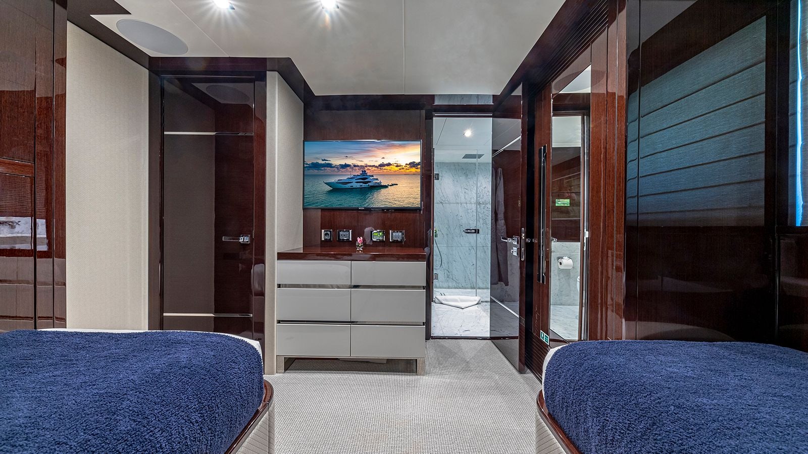 a room with a bed and a large mirror aboard CAPTAIN MORGAN III Yacht for Sale