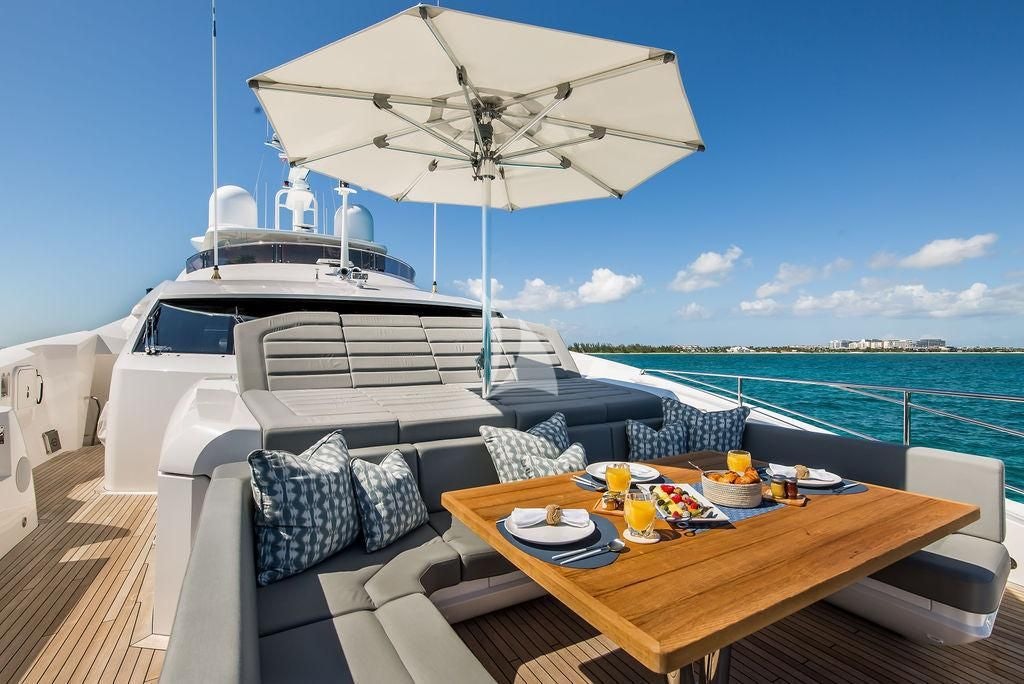 a table and chairs on a boat aboard CAPTAIN MORGAN III Yacht for Sale