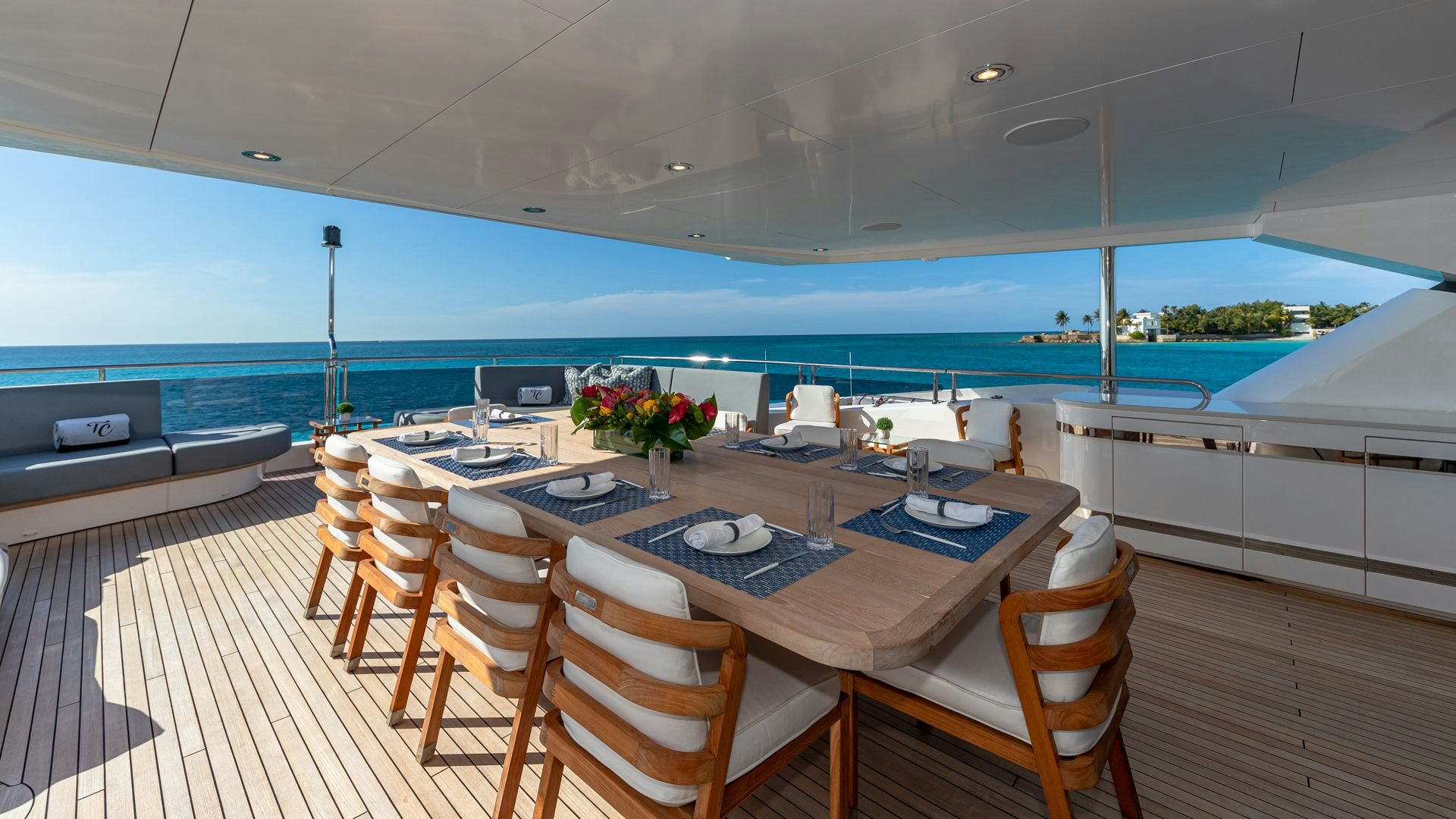 a large room with a table and chairs and a large body of water aboard CAPTAIN MORGAN III Yacht for Sale