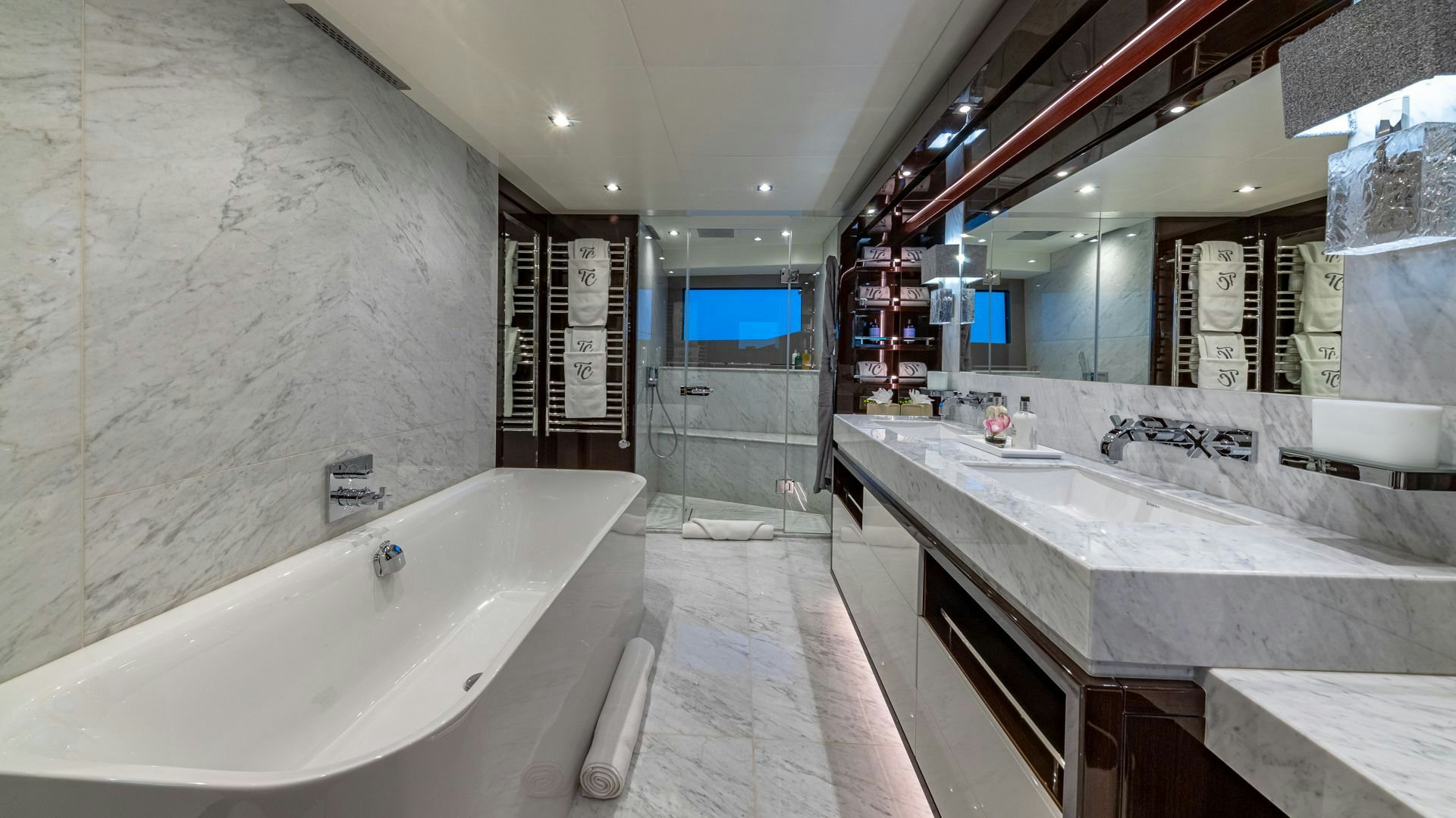 a bathroom with a large mirror aboard CAPTAIN MORGAN III Yacht for Sale