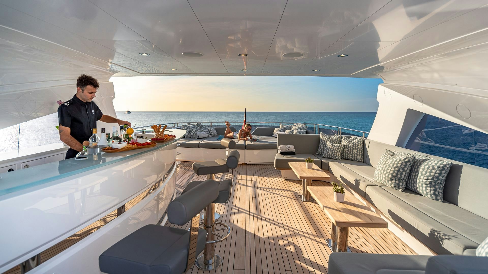 a person sitting at a table in a room with a large window aboard CAPTAIN MORGAN III Yacht for Sale
